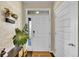Bright foyer with a white front door, decorative plant and views to the outdoors at 25262 E 2Nd Pl, Aurora, CO 80018