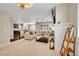 Open-concept living room flowing into the kitchen, featuring neutral tones and a cozy ambiance at 25262 E 2Nd Pl, Aurora, CO 80018