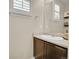 Clean powder room featuring a vanity with a sink, mirror and plantation shutters at 25262 E 2Nd Pl, Aurora, CO 80018