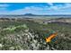 Aerial view highlighting the surrounding golf course and the expansive green space with mountain views at 7134 Kiowa Rd, Larkspur, CO 80118