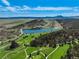 A beautiful shot of a golf course, surrounded by tree-filled landscape, scenic rock formations, and mountains at 7134 Kiowa Rd, Larkspur, CO 80118