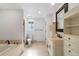 Bright bathroom with tile floors, soaker tub, toilet, and white decorative vanity with mirror at 7134 Kiowa Rd, Larkspur, CO 80118
