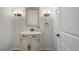 Bathroom with vanity and stylish fixtures with a neutral color palette and crisp white walls at 7134 Kiowa Rd, Larkspur, CO 80118
