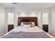 Stunning bedroom featuring built-in storage niches surrounding a large headboard and a stylish patterned comforter at 7134 Kiowa Rd, Larkspur, CO 80118