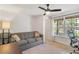 Bedroom featuring a comfy sofa, large window with blinds and a neutral color scheme, creating a peaceful retreat at 7134 Kiowa Rd, Larkspur, CO 80118