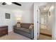 Cozy bedroom showing a comfortable sofa, closet access, and neutral tones that create a relaxing atmosphere at 7134 Kiowa Rd, Larkspur, CO 80118