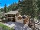 Stunning two-story home with a two car garage and a large driveway nestled amongst mature trees at 7134 Kiowa Rd, Larkspur, CO 80118