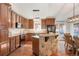 Gourmet kitchen featuring custom cabinetry, granite countertops, and a stone breakfast bar at 7134 Kiowa Rd, Larkspur, CO 80118