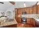 A spacious kitchen with stainless steel appliances, granite countertops, and light stone backsplash at 7134 Kiowa Rd, Larkspur, CO 80118