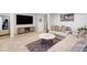 Living room with a large TV, comfortable sofa, accent rug, and open layout, perfect for relaxation and entertainment at 7134 Kiowa Rd, Larkspur, CO 80118