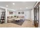 This living room is illuminated by recessed lights, and features a plush sofa, accent rug and stylish decorations at 7134 Kiowa Rd, Larkspur, CO 80118