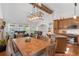 Open concept living room and kitchen with hardwood floors and wooden beams on vaulted ceilings at 7134 Kiowa Rd, Larkspur, CO 80118