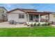 Backyard featuring a covered patio, well maintained lawn and rock features at 22583 E Union Cir, Aurora, CO 80015