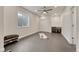 Finished basement with modern gray flooring, window, storage, and ceiling fan at 22583 E Union Cir, Aurora, CO 80015