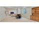 Basement space with a bar area featuring a hutch and bar stools, and a view of the open living area at 22583 E Union Cir, Aurora, CO 80015