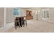 Basement space featuring a bar area with seating, a built-in hutch, and carpet flooring at 22583 E Union Cir, Aurora, CO 80015