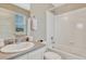 Well-lit bathroom featuring a white vanity, sink, toilet, and a shower/tub combination with white tile surround at 22583 E Union Cir, Aurora, CO 80015