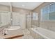 Bright bathroom featuring a tiled shower, soaking tub, vanity and neutral decor at 22583 E Union Cir, Aurora, CO 80015