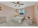 Charming bedroom featuring a hanging chair, desk, and a plush bed under a ceiling fan at 22583 E Union Cir, Aurora, CO 80015