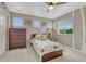 Bedroom featuring a ceiling fan, large window, plush bedding, and a handsome dresser at 22583 E Union Cir, Aurora, CO 80015