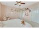A pretty pink bedroom with a hanging swing, queen bed, and large window at 22583 E Union Cir, Aurora, CO 80015