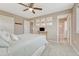 Neutral bedroom featuring a ceiling fan, decorative wall art, and an ensuite bathroom with a tub and shower at 22583 E Union Cir, Aurora, CO 80015