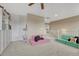 A brightly lit bonus room with comfortable seating and stairway access to other areas of the home at 22583 E Union Cir, Aurora, CO 80015
