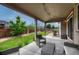 Backyard covered patio with furniture and well-maintained lawn in the background at 22583 E Union Cir, Aurora, CO 80015
