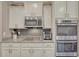 Modern kitchen with stainless steel appliances, granite countertops, a gas cooktop, and sleek white cabinetry at 22583 E Union Cir, Aurora, CO 80015