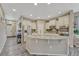 Spacious kitchen with granite countertops, stainless steel appliances, a large island, and modern gray wood flooring at 22583 E Union Cir, Aurora, CO 80015