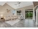Bright living room with vaulted ceiling, and sliding glass doors to the backyard at 22583 E Union Cir, Aurora, CO 80015