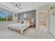 Main bedroom with tray ceiling, ensuite bathroom, and lots of natural light at 22583 E Union Cir, Aurora, CO 80015