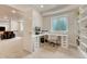 Bright home office space featuring built-in shelving, a large desk, and carpeted floors at 22583 E Union Cir, Aurora, CO 80015
