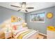 Comfortable bedroom featuring a ceiling fan and a window overlooking the neighborhood at 3149 Wheeling St, Aurora, CO 80011