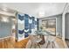 Bright dining area featuring a glass table set and unique accent wall, perfect for entertaining guests at 3149 Wheeling St, Aurora, CO 80011