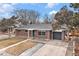 A well-maintained brick home featuring a driveway, garage, and manicured lawn creating curb appeal at 3149 Wheeling St, Aurora, CO 80011