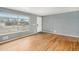 Bright, empty living room with hardwood floors, a large window and freshly painted walls, ready for new residents at 3149 Wheeling St, Aurora, CO 80011