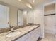 Well-lit bathroom with granite countertops, double sinks, and a shower/tub combo at 8390 E Summit Rd, Parker, CO 80138