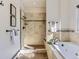 Bathroom featuring a soaking tub, glass enclosed shower, neutral tile and modern fixtures at 8390 E Summit Rd, Parker, CO 80138