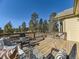 Inviting wooden deck featuring stylish outdoor furniture and a serene view of the surrounding pine trees at 8390 E Summit Rd, Parker, CO 80138