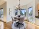 Bright dining area with a round wood table, chandelier, and large windows providing beautiful views of the landscape at 8390 E Summit Rd, Parker, CO 80138