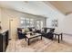 Bright living room featuring comfortable leather seating, a large rug, natural light, and neutral walls at 8390 E Summit Rd, Parker, CO 80138