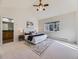 Bright main bedroom featuring a large window, a ceiling fan and an ensuite bathroom at 8390 E Summit Rd, Parker, CO 80138