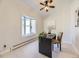 Home office with a bay window, neutral carpet, and a sleek dark desk with a modern chair at 8390 E Summit Rd, Parker, CO 80138