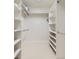 Walk-in closet featuring built in shelves, hanging rods and neutral carpet at 8390 E Summit Rd, Parker, CO 80138