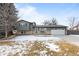 Ranch style home with attached garage and snow-covered yard at 446 Dione Pl, Lone Tree, CO 80124