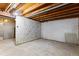 Unfinished basement with exposed beams and concrete walls at 446 Dione Pl, Lone Tree, CO 80124