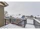 Snowy deck with a metal railing and view of neighboring homes at 1405 Willow Oak Rd, Castle Rock, CO 80104