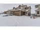 Two-story townhome with attached garage, winter scene at 1405 Willow Oak Rd, Castle Rock, CO 80104