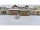 Two story townhome, double attached garage, snow on ground at 1405 Willow Oak Rd, Castle Rock, CO 80104